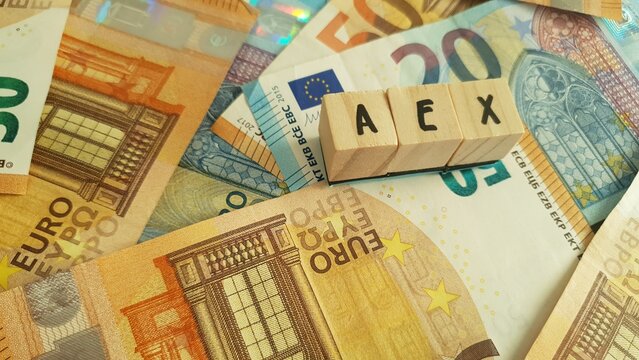 AEX acronym made of wooden letter cubes on pile of Euro banknotes. Amsterdam Exchange Index (Dutch stock market index)