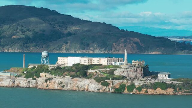 Telephoto panning aerial shot of Alcatraz Island in the middle of San Francisco Bay in Northern California. 4K