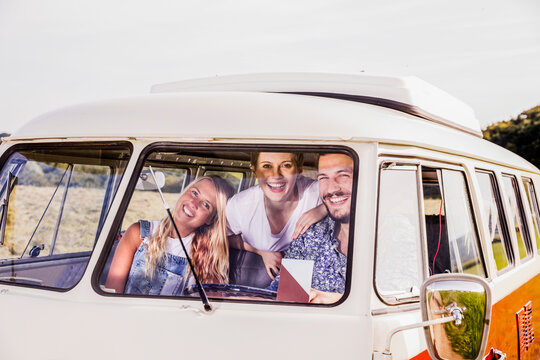 Happy friends inside van