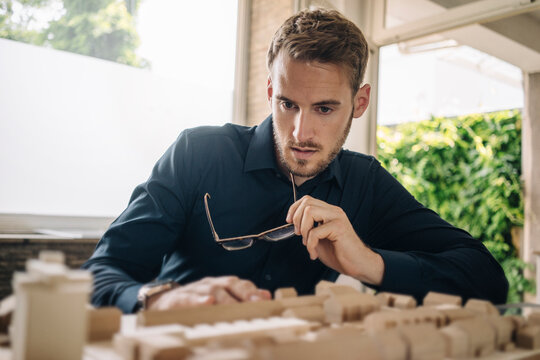 Architect looking at urban development model