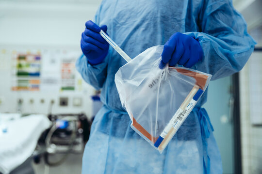 Close-up of emergeny doctor putting a swab into a plastic bag in hospital