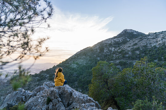 Person finding solitude and freedom hiking at sunset