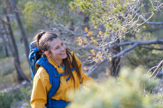 Woman hiking in forest looking to nature