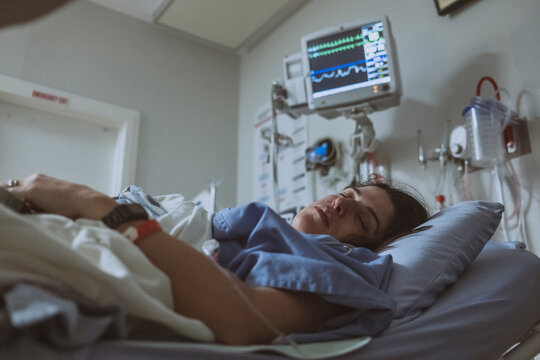 Woman Resting in Hospital Bed Under Medical Monitoring for heart issue
