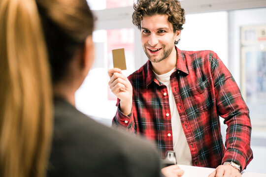 Man paying with credit card at the counter of a shop