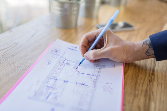 Close-up of architect working on construction plan