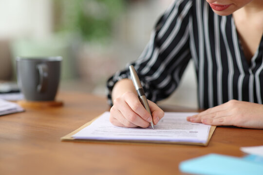 Close up of a self employed hand signing contract
