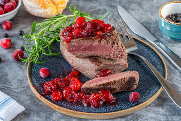 Roasted ostrich loin with cranberry and orange sauce