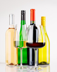 Obraz premium Different wine bottles and glasses on white background