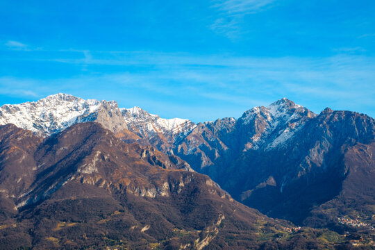 Alpine mountains surrounding Lake Como, snow-capped peaks and rugged Italian landscape, scenic nature and travel destination