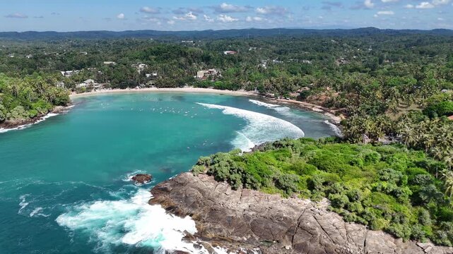 Beautiful tropical bay with clear blue water and surfers, Sri Lanka, Hiriketiya, Dikwella, Asia. Drone