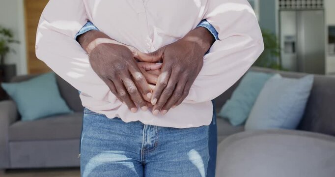Partner behind is initiating embrace and is adjusting interlaced hands in living room to comfort