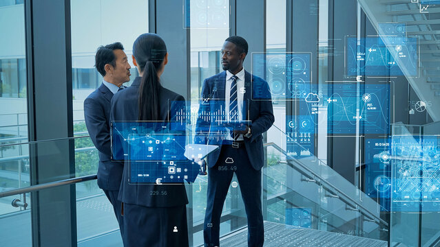 Multinational business people conversing and digital technology