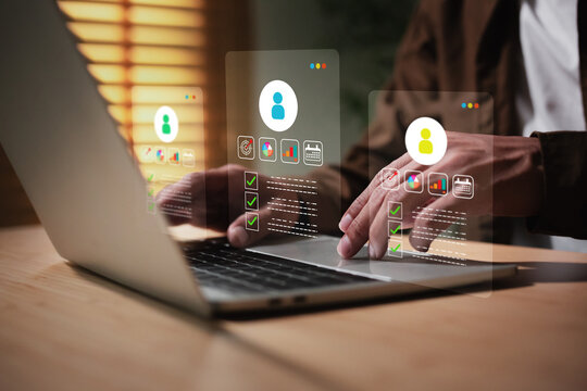 Man is working on a laptop,  displaying customer profiles or human resources (HR), Customer Relationship Management (CRM), and personal data management
