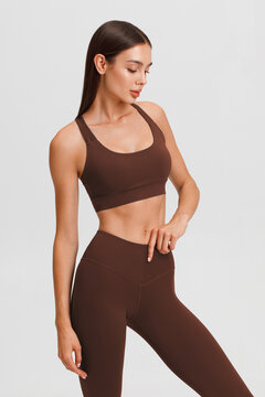 Athletic girl on the gray background. Fitness woman