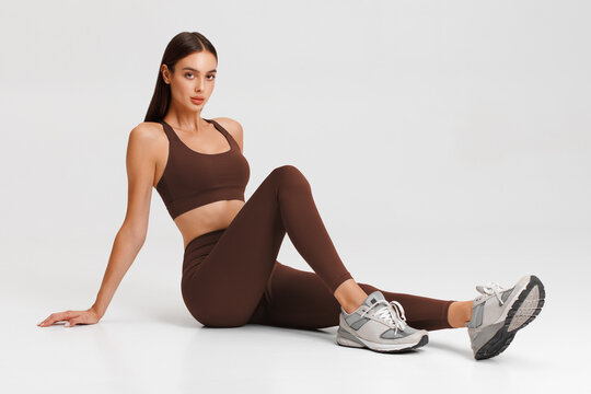 Athletic girl on the gray background. Fitness woman