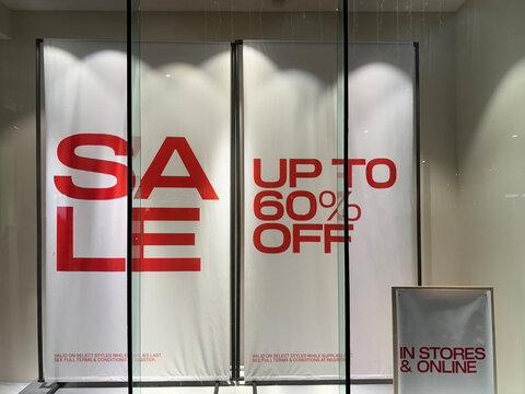 White bunner on a wall with red inscription: Sale up to 60% off
