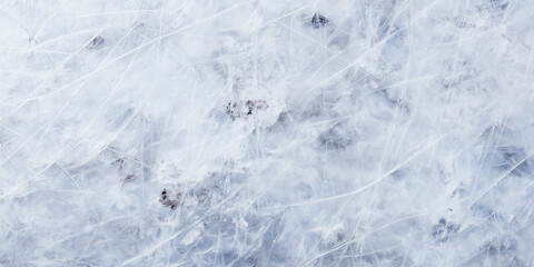 Obraz premium Textured ice surface showing many skate marks and scratches, reflecting the cold of winter and winter sports