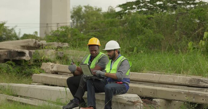 Railway engineer and technician conduct quality control material inspection on concrete pier segments and construction waste. Checking structural condition for safe site housekeeping and asset reuse.
