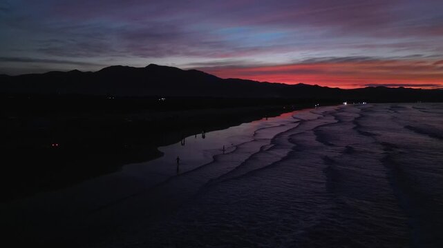 Wide aerial showing Eztanza Beach at sunset with calm waves, golden sky, and tropical coastal scenery in Lingayen.
