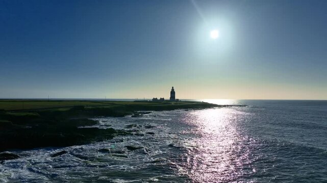 Aerial low over sea early morning at Hook Head Lighthouse sentinel over the Atlantic Ocean