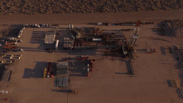 Drone view of Vaca Muerta oil field industry at sunset