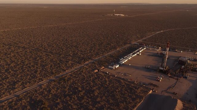 Aerial view of Vaca Muerta oil field, industrial operations at sunset