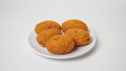 A snack called combro, typical of West Java, Indonesia, made from cassava with oncom chili sauce filling, served on a white plate and placed in a white place (isolated white).