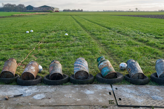Old milk cans in a row. Carbide shooting or carbidschieten in dutch is a tradition in the Netherlands and usually takes place on New Year's Eve. The goal is to make a loud bang after the carbide	
