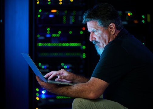 Man using laptop in data center