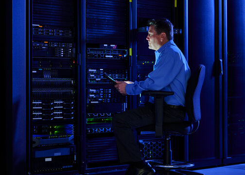 Man using digital tablet in data center