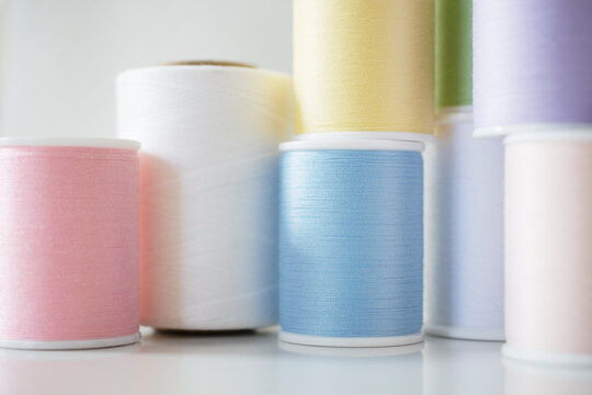 Studio shot of spools of pastel colored thread