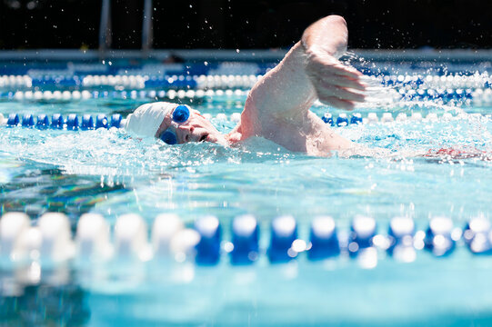Man swimming laps in outdoor pool