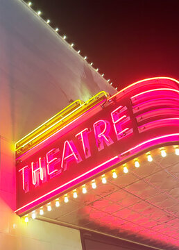 Illuminated theater marquee at night