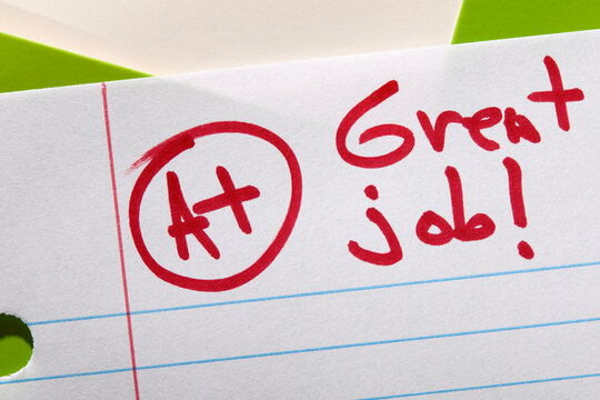 Close-up of A+ grade on lined paper