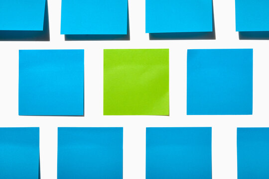 Blue and green post it notes on white background