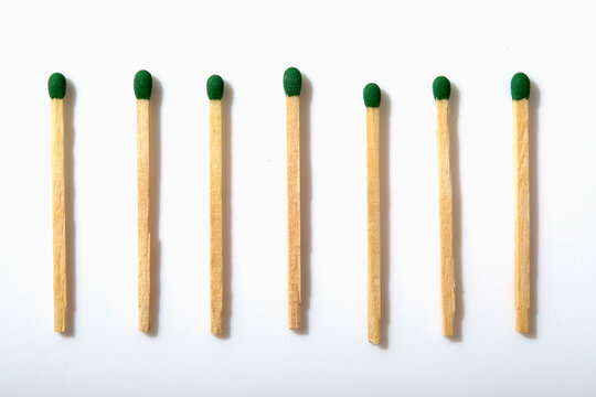 Row of matchsticks on white background