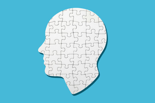 White head shaped puzzle on blue background