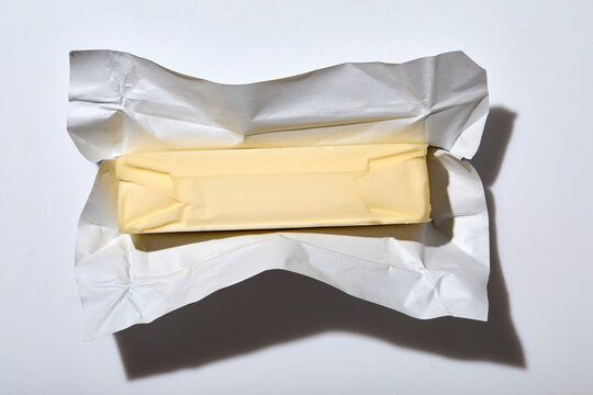Overhead view of stick of butter on white background