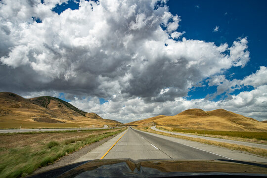 USA, Utah, Snowville, Empty road and clouds seen from car
