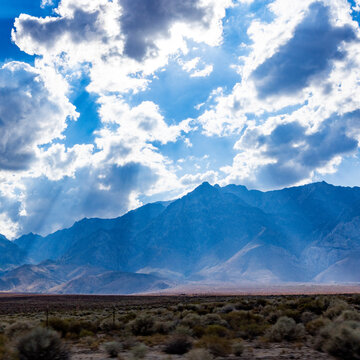 USA, California, Lone Pine, Sunbeams shining through clouds above mountains
