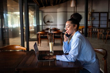 Remote work, communication. African american business woman on a phone call with a laptop working