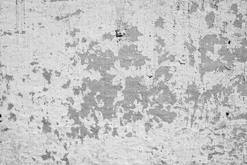Grungy abstract background texture of an old weathered concrete wall with peeling gray plaster © reddish