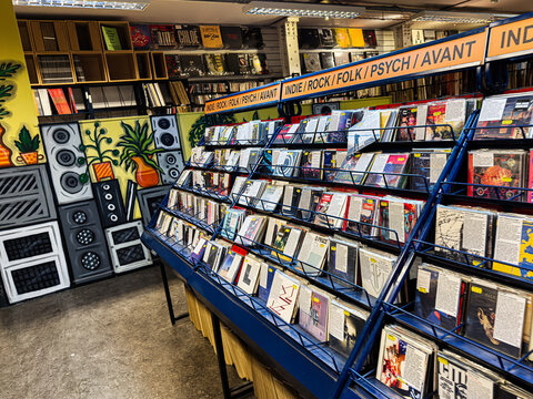 Vibrant record store aisles with colorful vinyl albums and indie rock displays