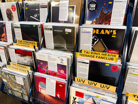 Vinyl records in a store display featuring Bruce Springsteen, Talking Heads, and The Stone Roses