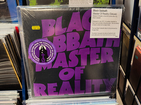 Black Sabbath Master of Reality vinyl cover on display with bold purple typography
