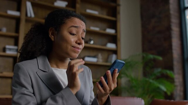 Worried Woman Reading Layoff Message on Phone