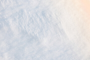 Obraz premium Pristine white winter snow surface with subtle texture and soft warm sunlight creating a beautiful gradient