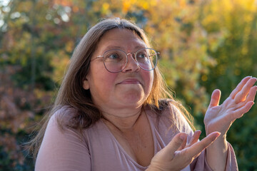 Playful woman making funny face, funny freak portrait with playful gestures, whimsical expression, Spontaneous moment captured outdoors