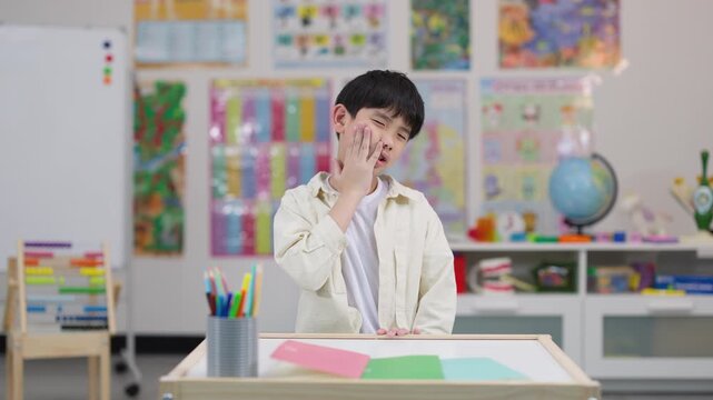 Young Student Experiencing Toothache in Classroom Setting
